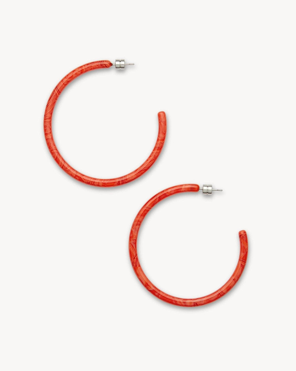 Large Poppy-colored hoops earrings by MACHETE, showcasing bold, round hoop design with a vibrant red-orange hue.