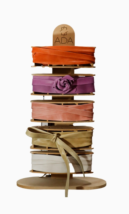 Berry suede wrap belt from ADA Collection Belts, one-size statement accessory shown coiled with textured fabric.