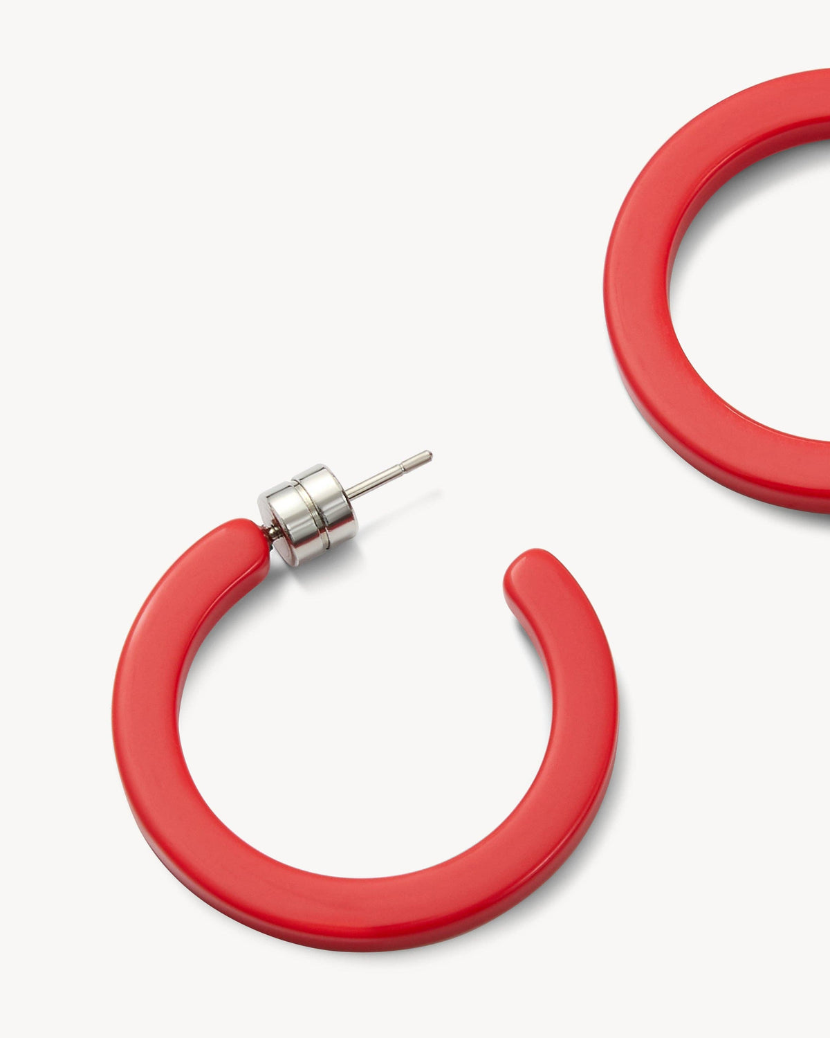 MACHETE Mini Ruby Hoop Earrings featuring small, vibrant ruby-colored hoops with gold-tone accents.