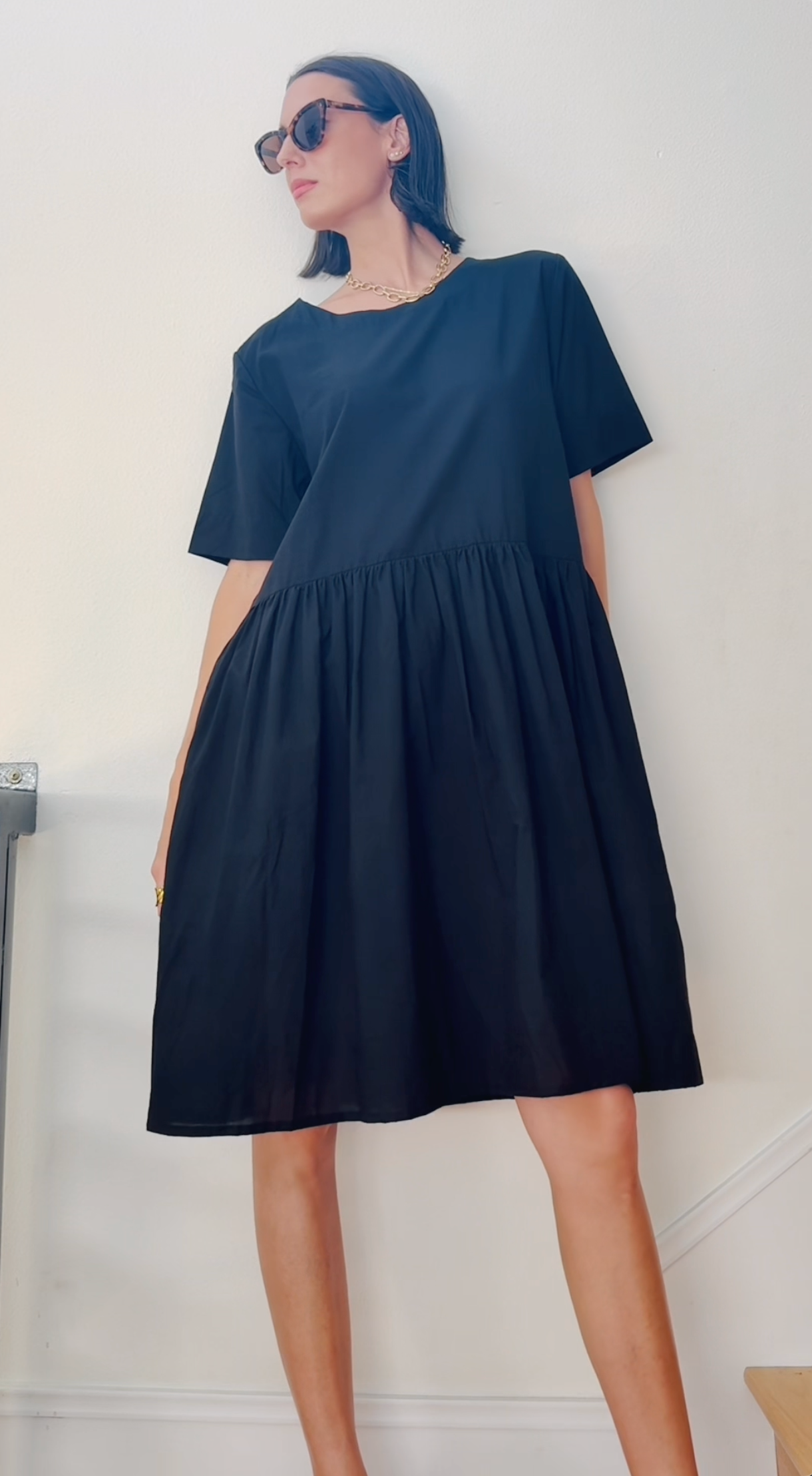 Black Hudson dress by and for Good, featuring a sleek, fitted silhouette and elegant design, displayed on a model.