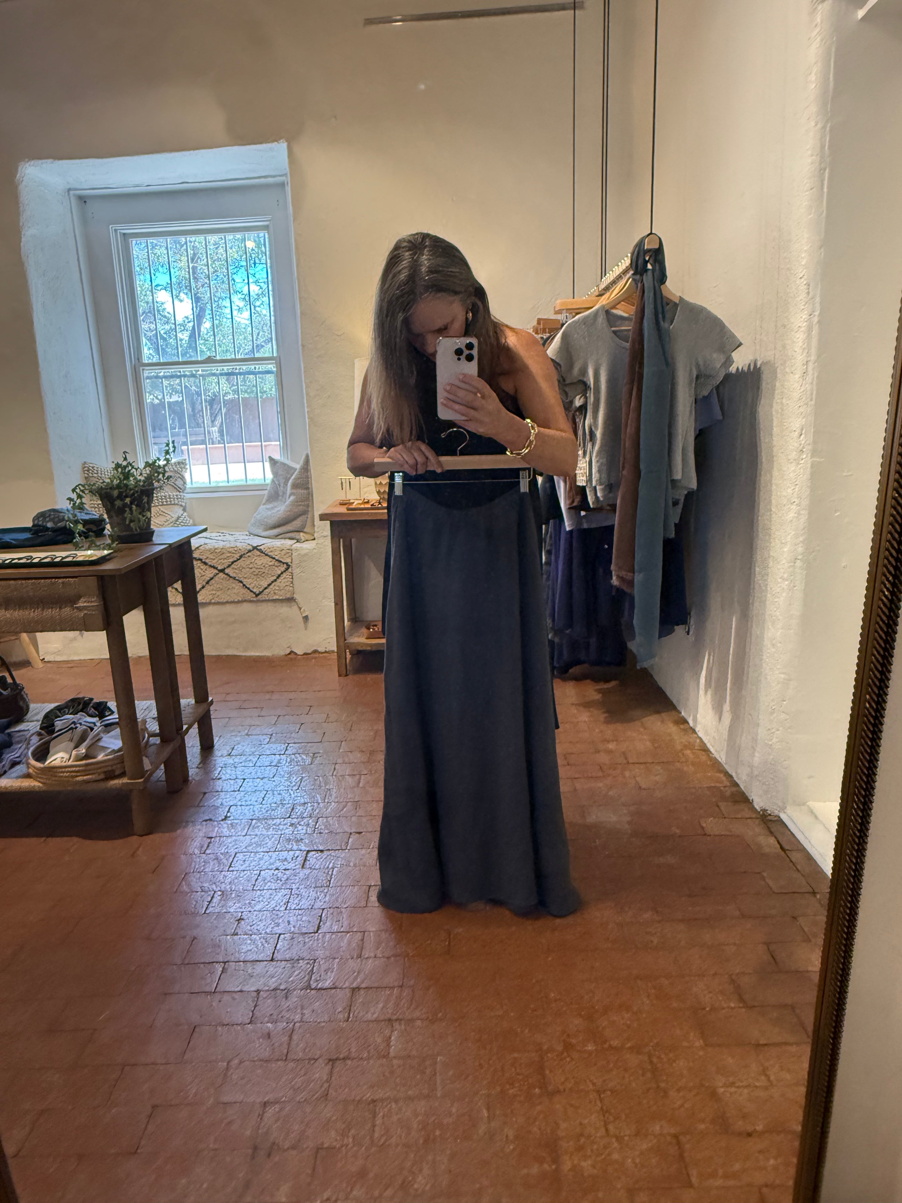 Sonrisa skirt displayed on a hanger, featuring a flowy fabric with a stylish design and vibrant color.