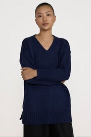 Navy oversized V-neck cotton sweater by Laude the Label, featuring a relaxed fit and soft knit texture.