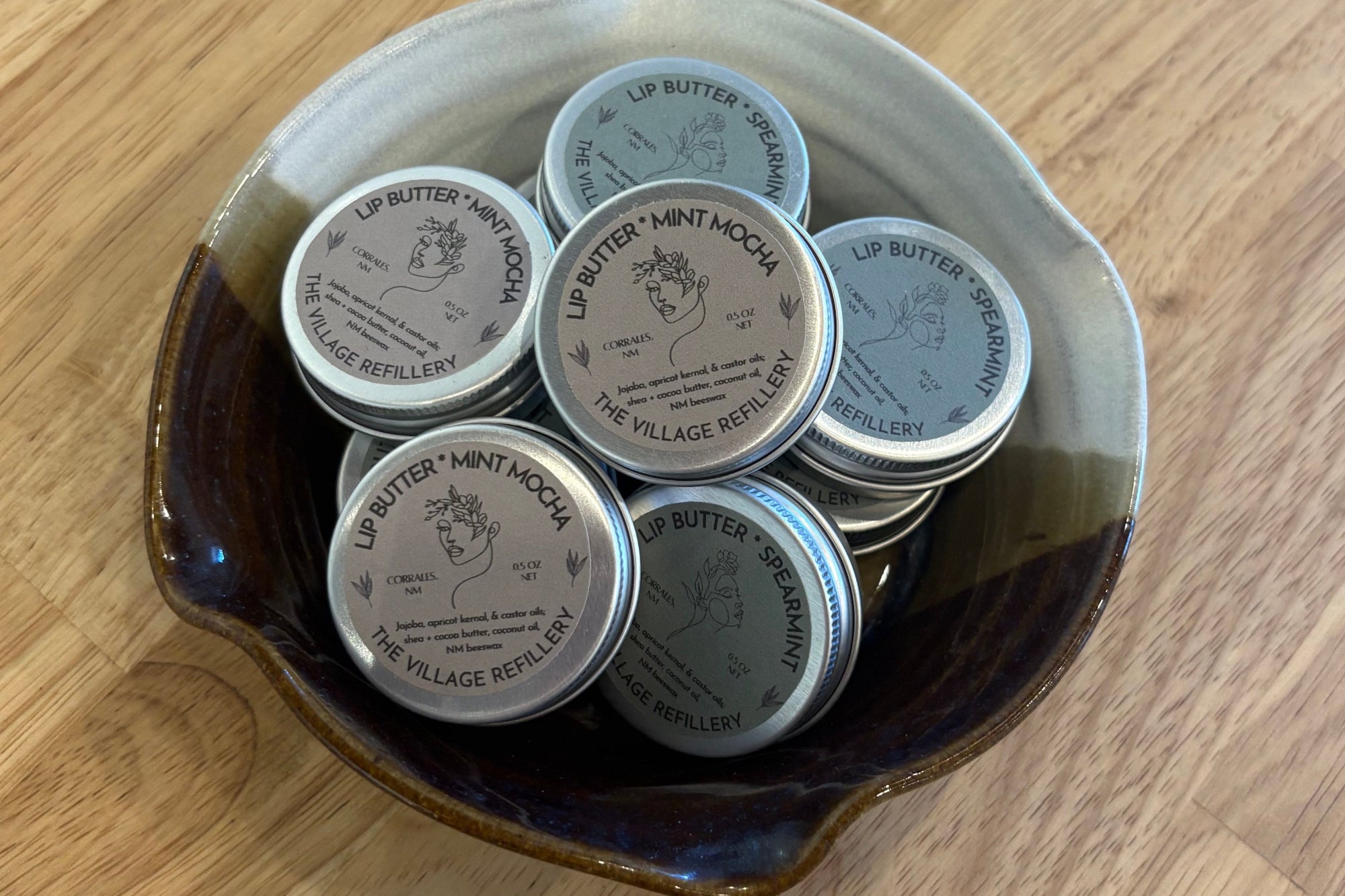 Round tins of Lip Butter in a vintage ceramic dish