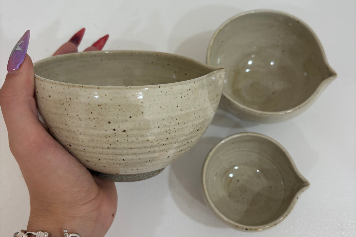 Set of handmade ceramic nesting bowls by Innovate Ceramics, showcasing smooth, earthy-toned pottery for kitchen use.