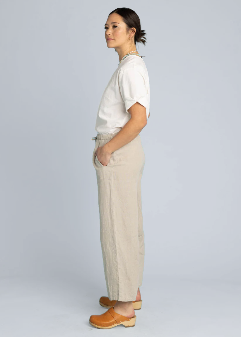 Natural flax linen Shore Pant by and for Good showing lightweight, relaxed-fit fabric in neutral tones.