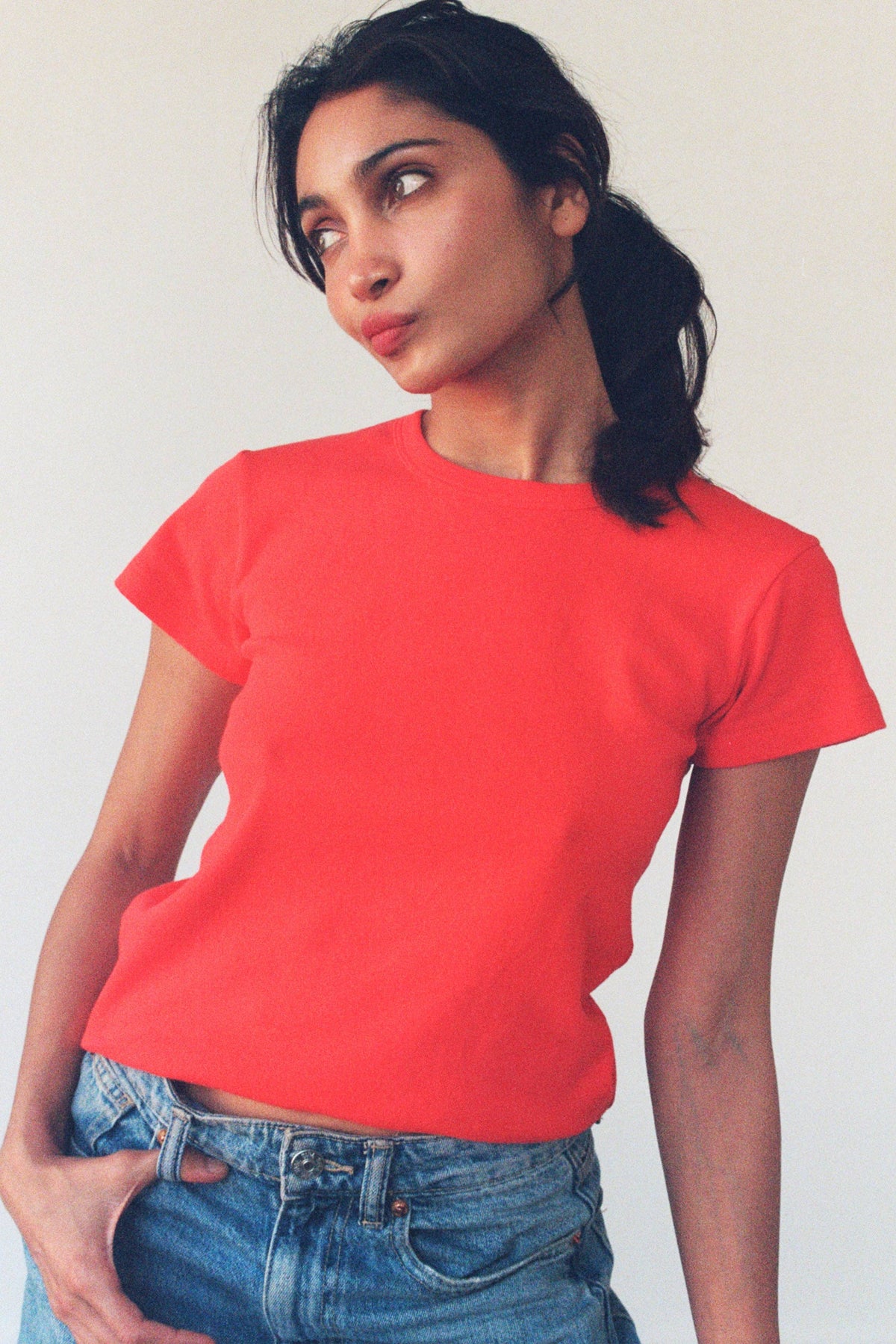 Pointelle baby tee by LA RELAXED featuring delicate knit fabric and short sleeves, shown in a soft pastel color.
