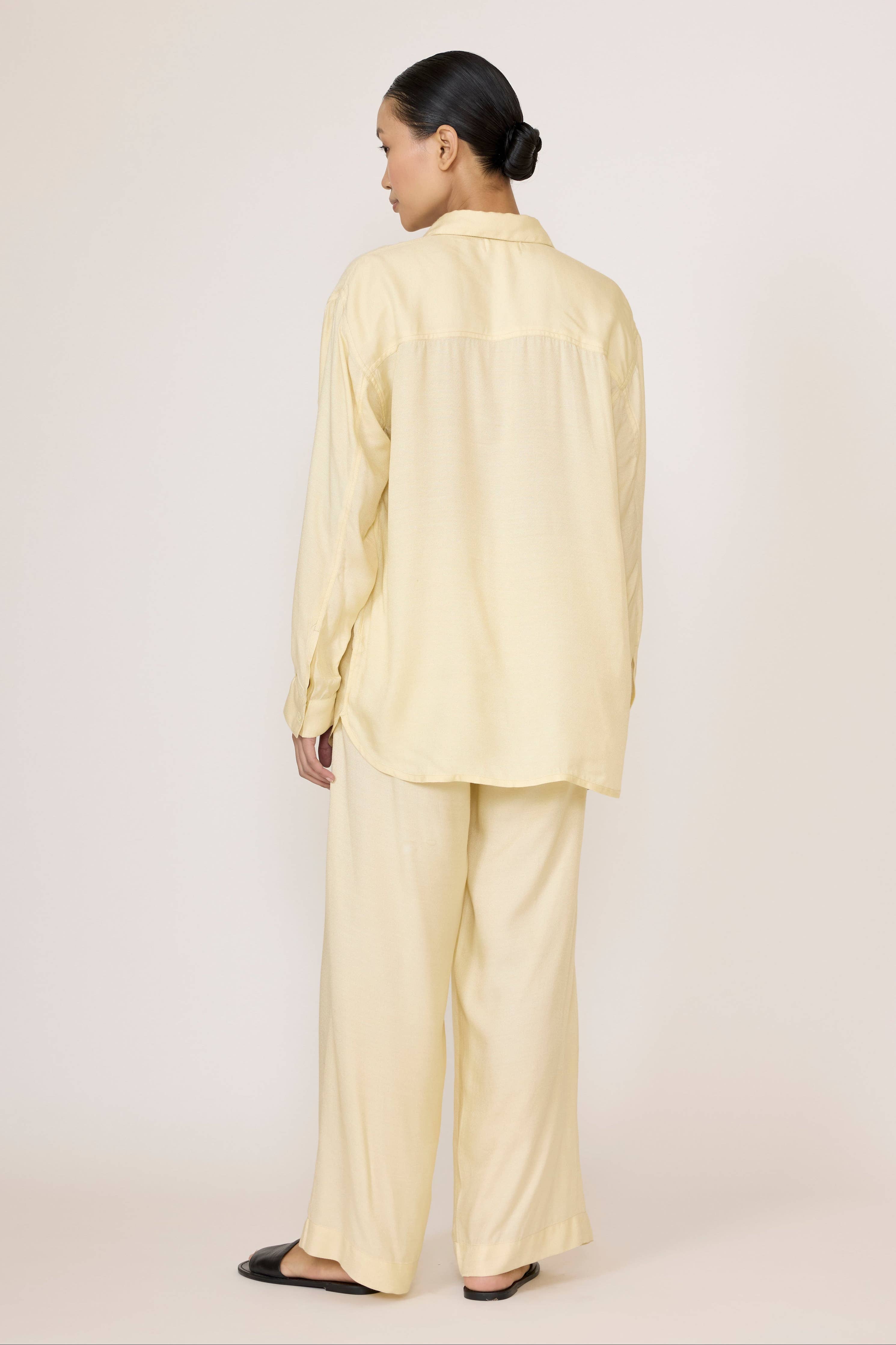 Light beige Easy Pant by LAUDE with a relaxed fit, shown on a mannequin, featuring a comfortable waistband and tapered legs.