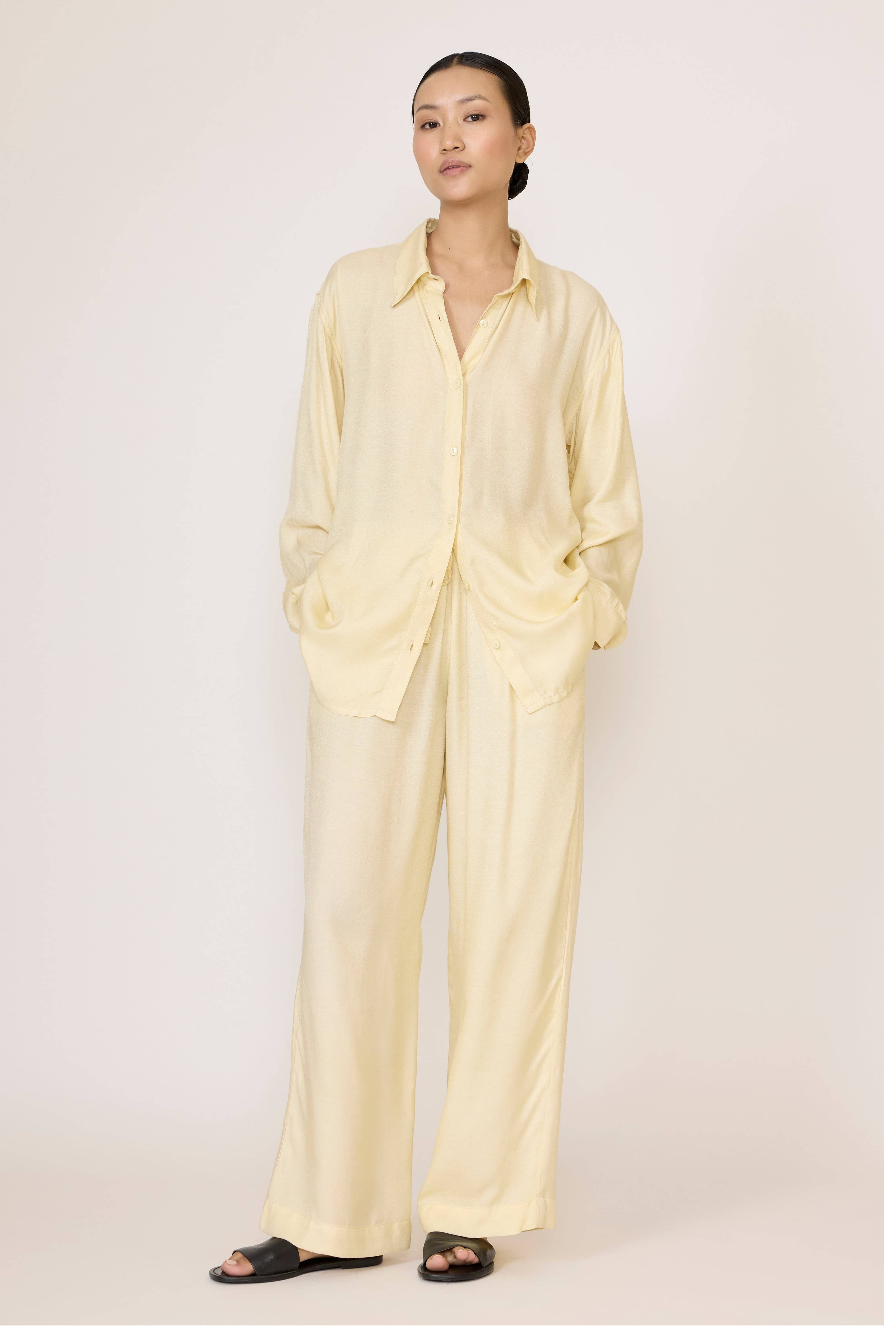 LAUDE Everything Shirt in Butter color, casual button-up with soft fabric and classic fit, displayed on a hanger.