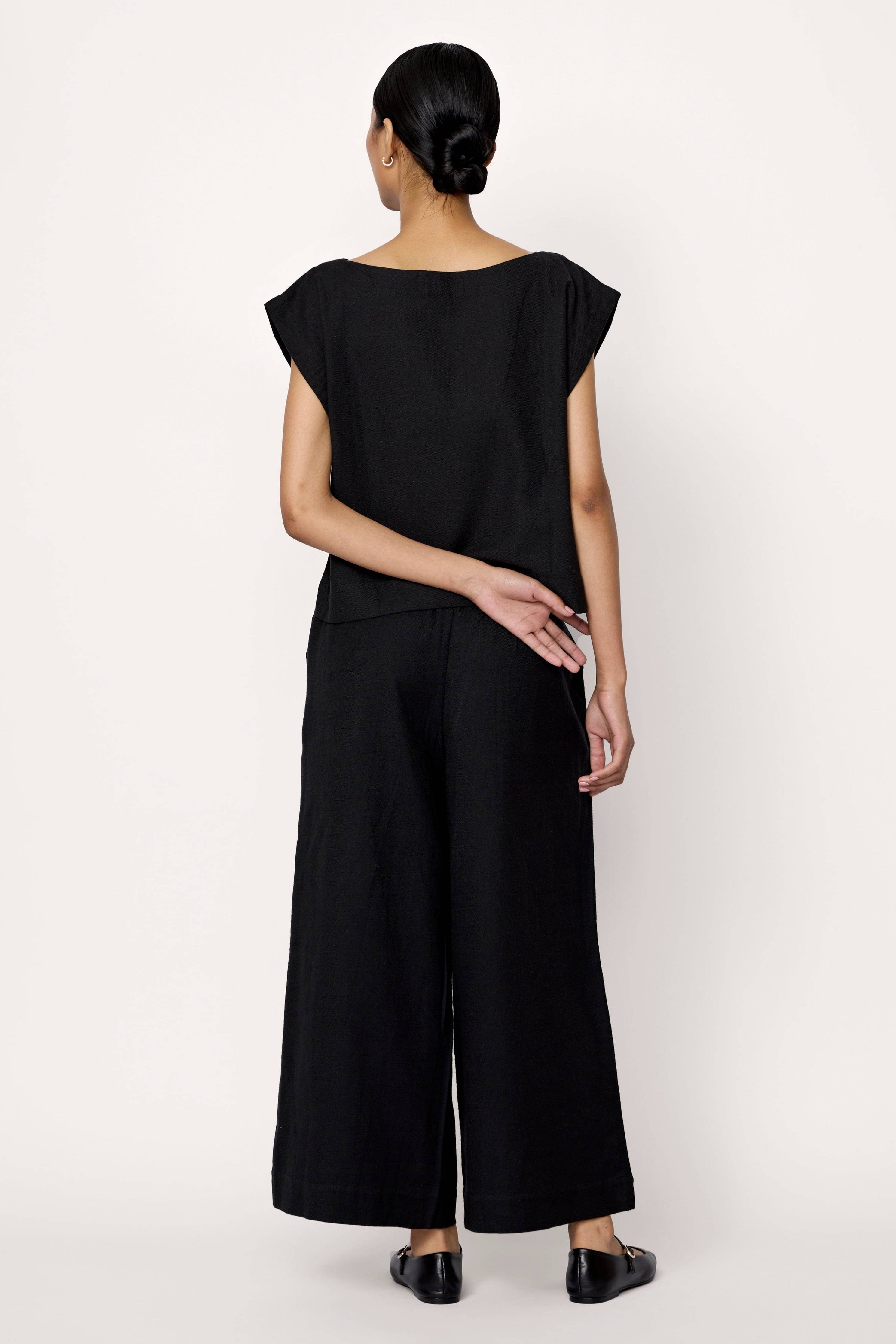 Black everyday pants by LAUDE, featuring a comfortable fit and classic design, shown in a front view.