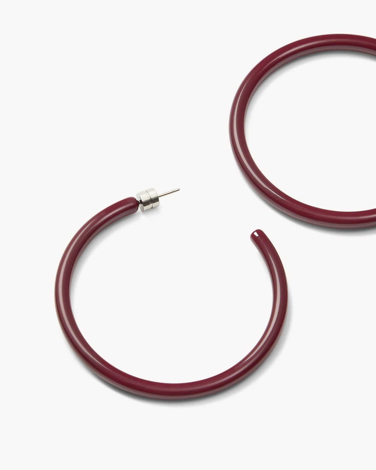 Large oxblood hoops earrings by MACHETE, featuring bold circular design, shiny finish, and stylish fashion accessory.
