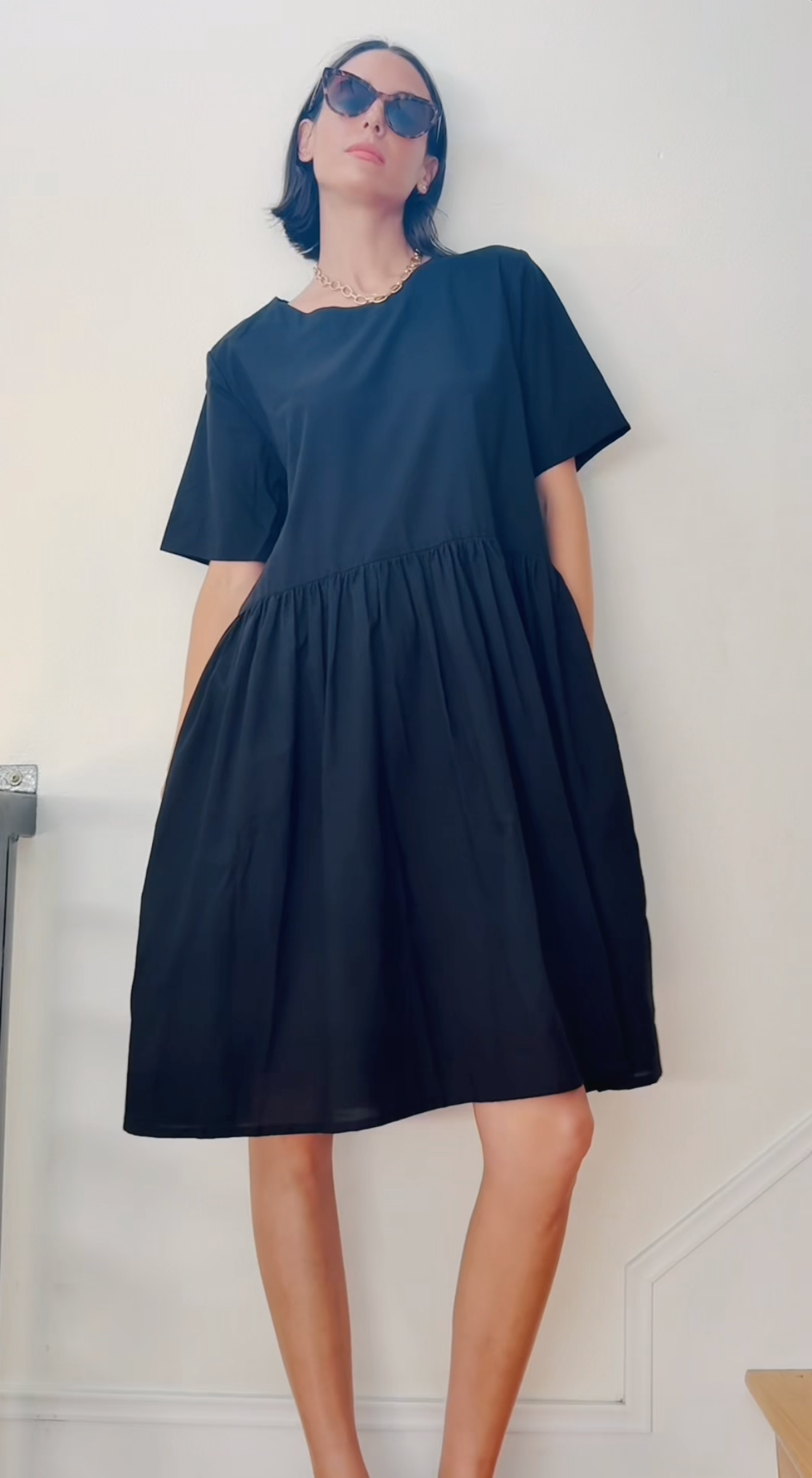 Black Hudson dress by and for Good, featuring a stylish, fitted design with subtle detailing, displayed on a hanger.
