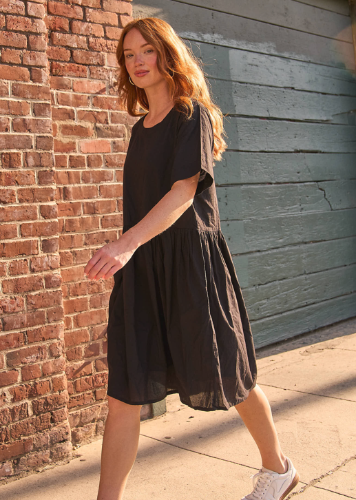 Black Hudson dress by and for Good, featuring a stylish silhouette and elegant fabric, displayed on a hanger.