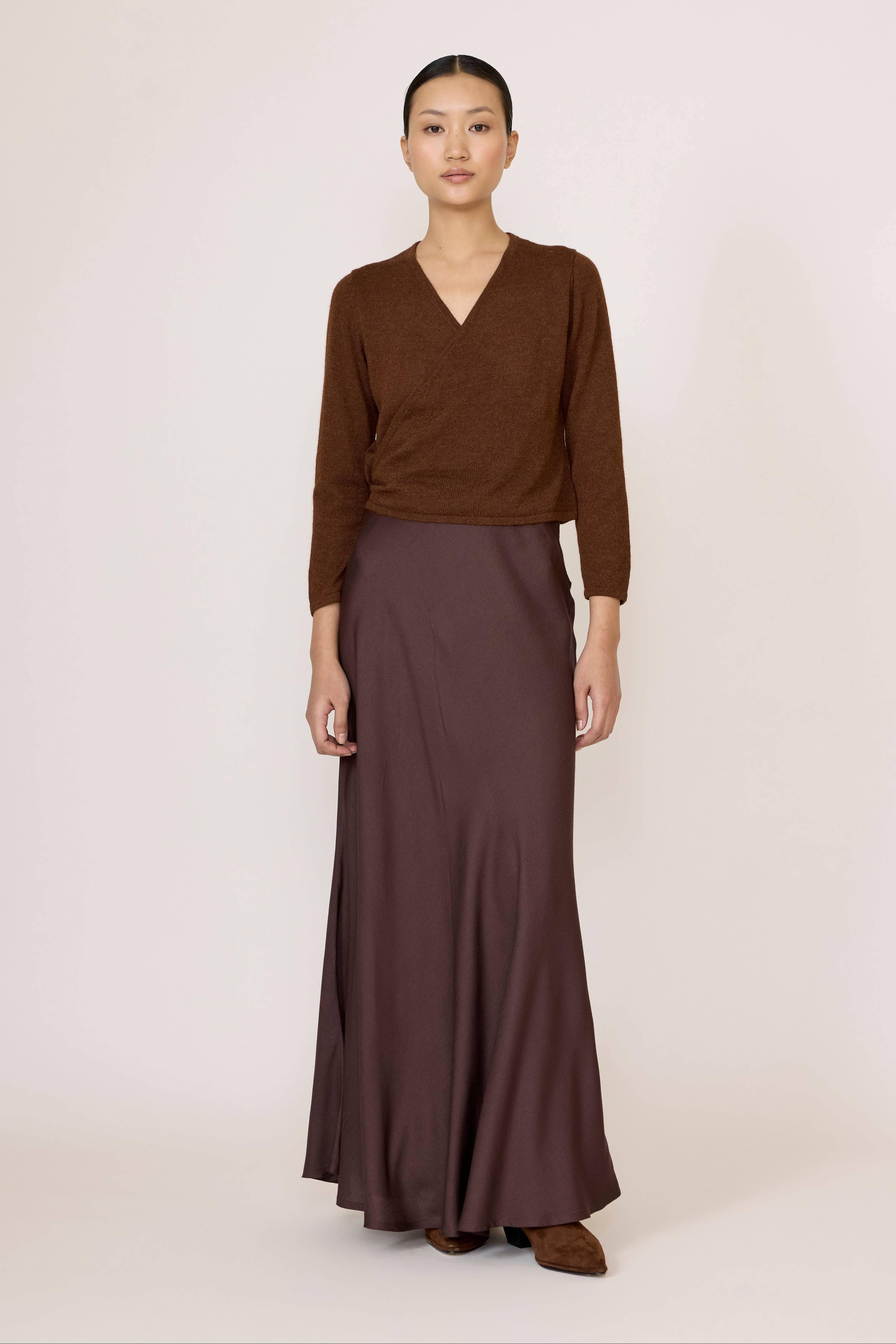 Chocolate brown bias maxi skirt by LAUDE, featuring a flowing design and elegant length shown in the image.