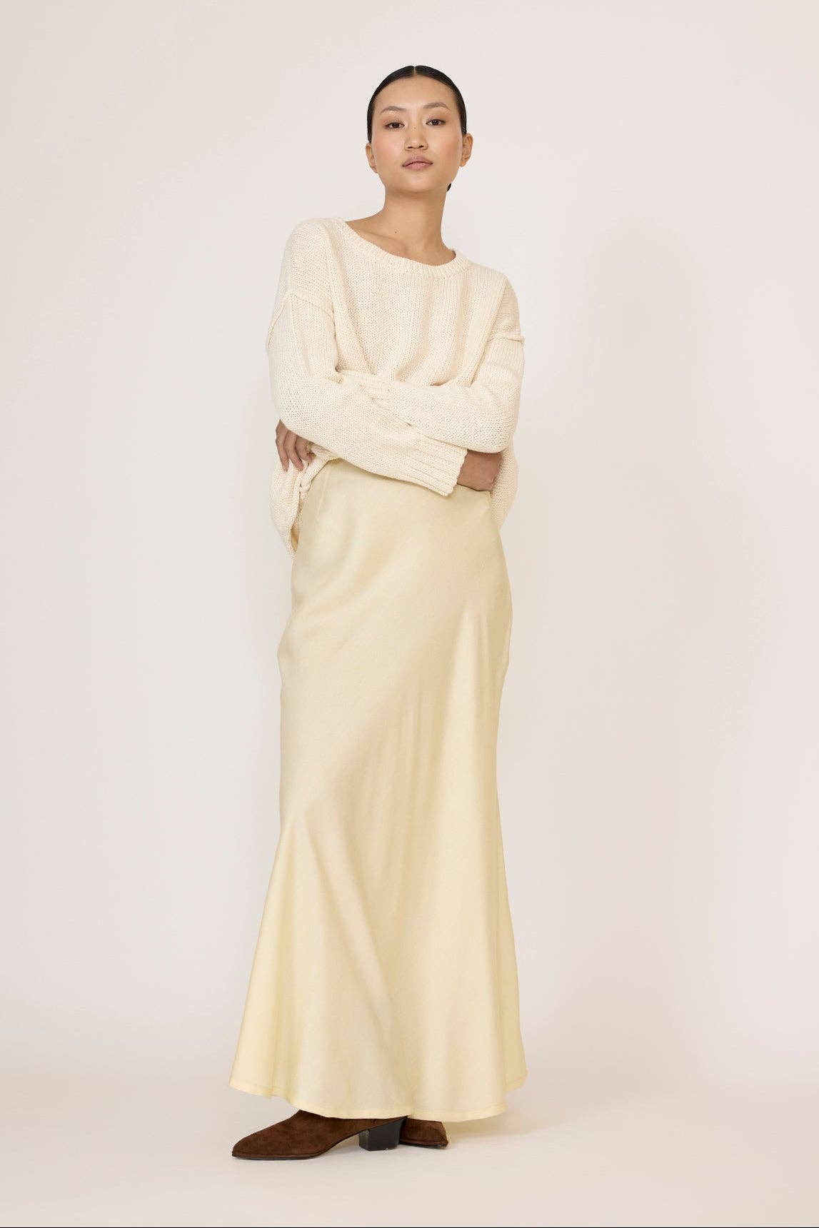 Ivory oversized crewneck sweater by LAUDE, soft knit fabric, relaxed fit, shown on a model highlighting its cozy, casual style.