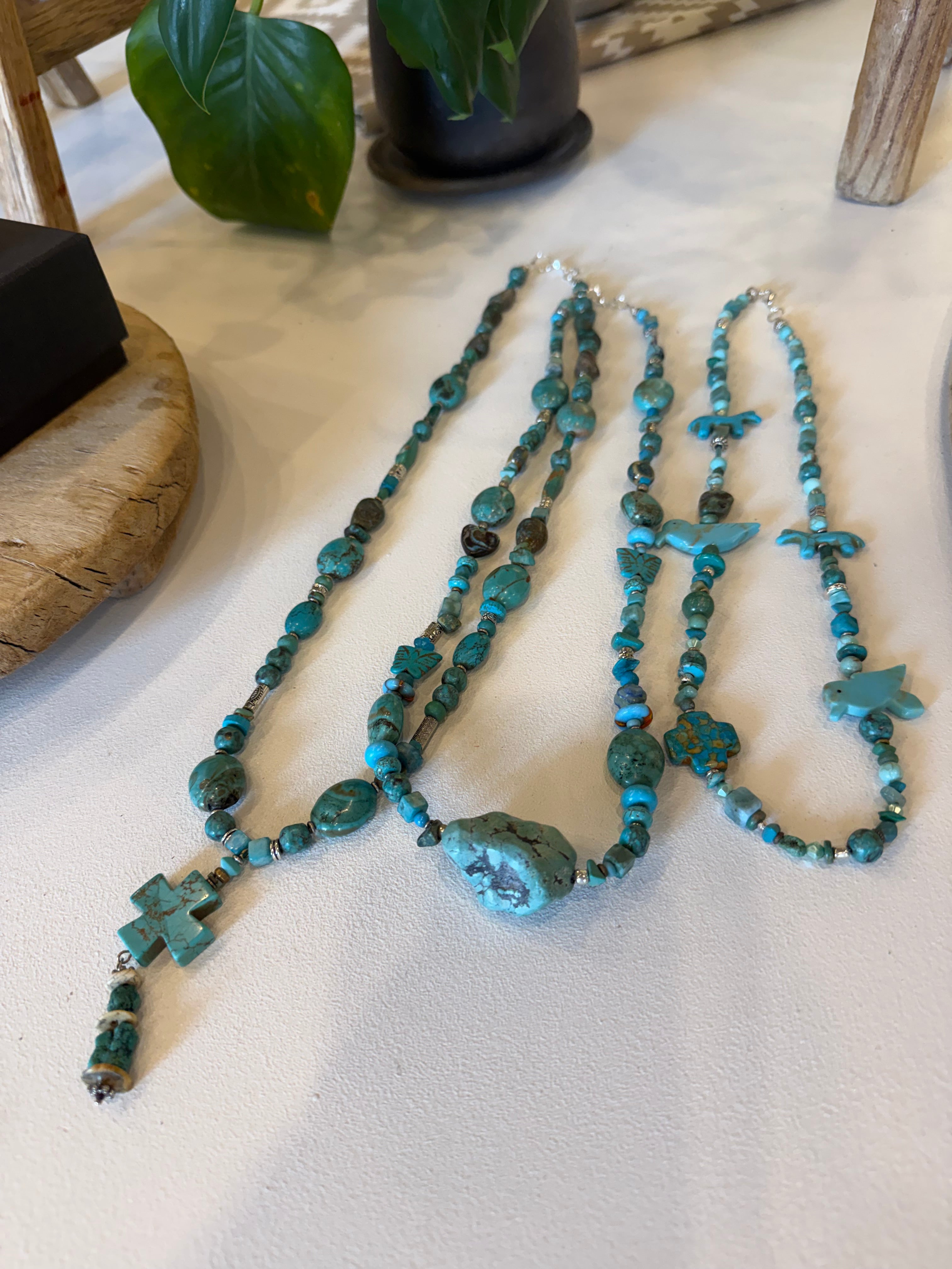 Shruska turquoise necklace featuring vibrant blue beads and intricate silver accents, styled as a jewelry necklace.