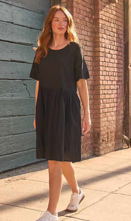 Black Hudson dress by and for Good featuring a fitted silhouette and elegant design, displayed on a hanger.