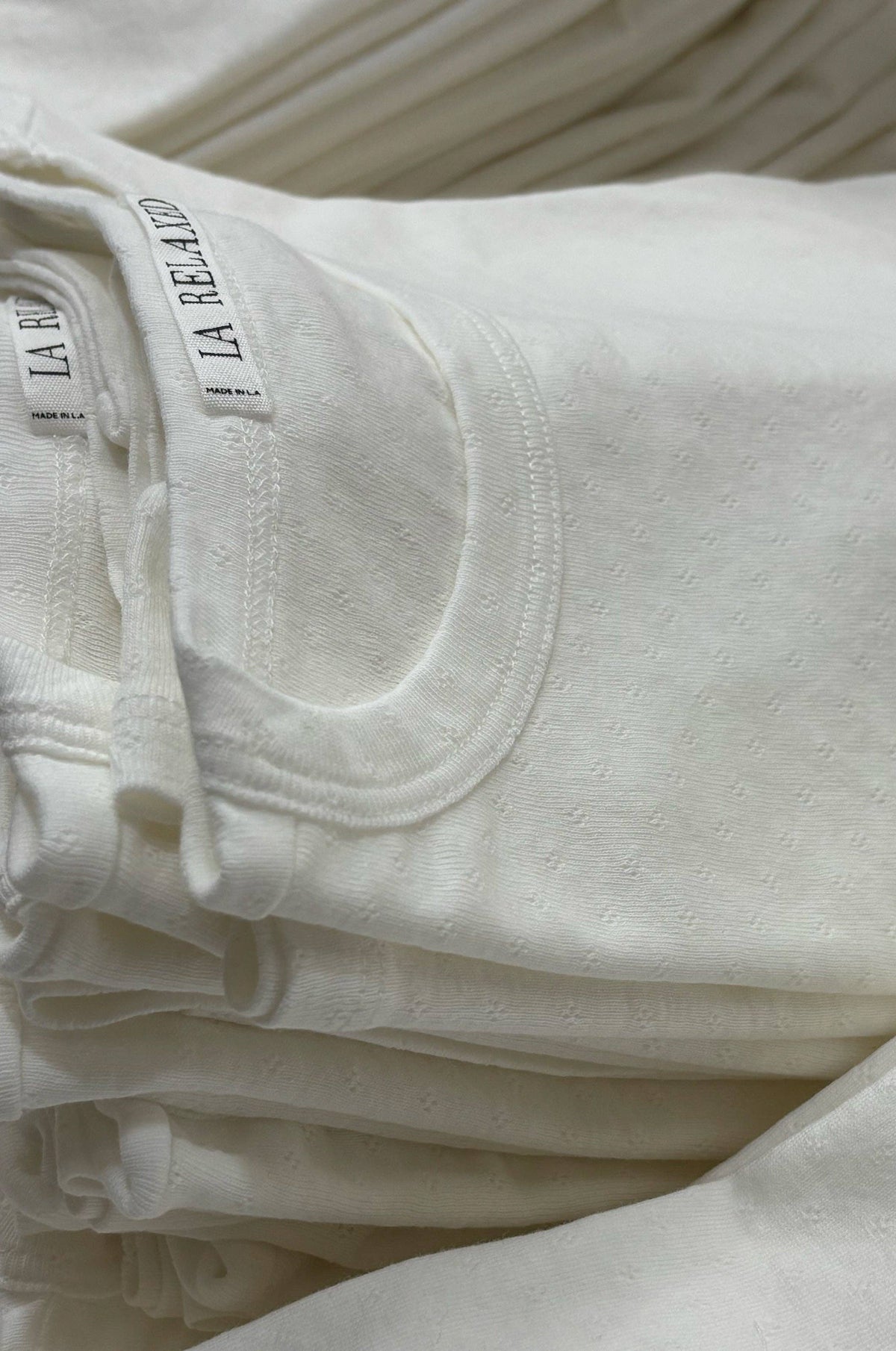 Pointelle baby tee by LA RELAXED featuring a soft, lightweight knit with delicate openwork details and short sleeves.