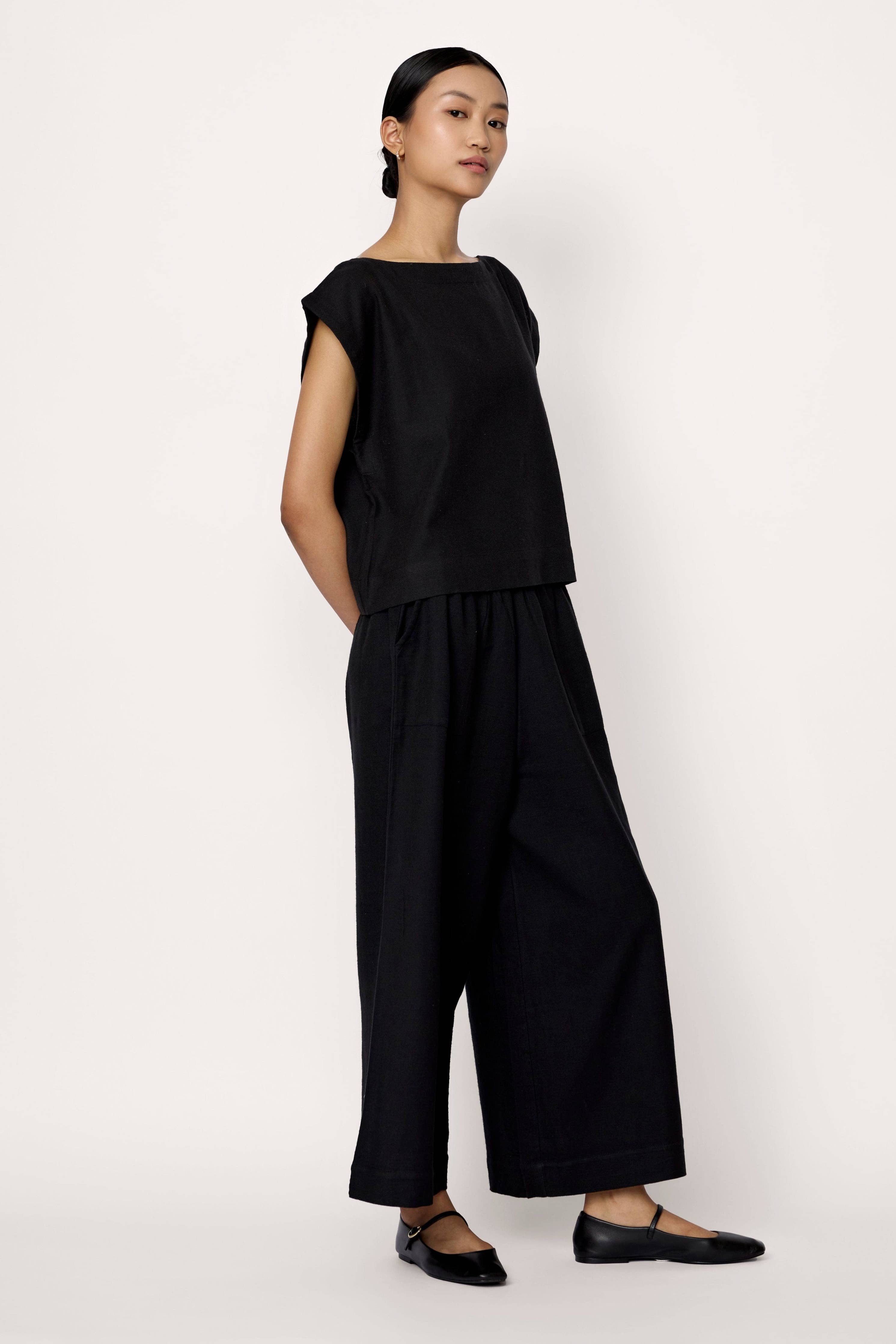 Black LAUDE Everyday Pant laid flat, showing their relaxed fit and soft fabric ideal for casual wear.