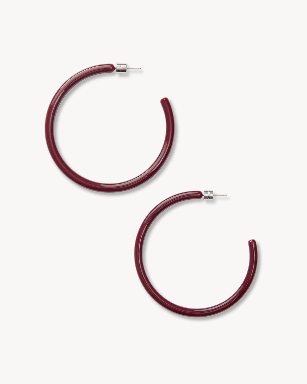 Large oxblood hoops earrings by MACHETE, stylish circular jewelry piece with a bold, deep red color and smooth finish.