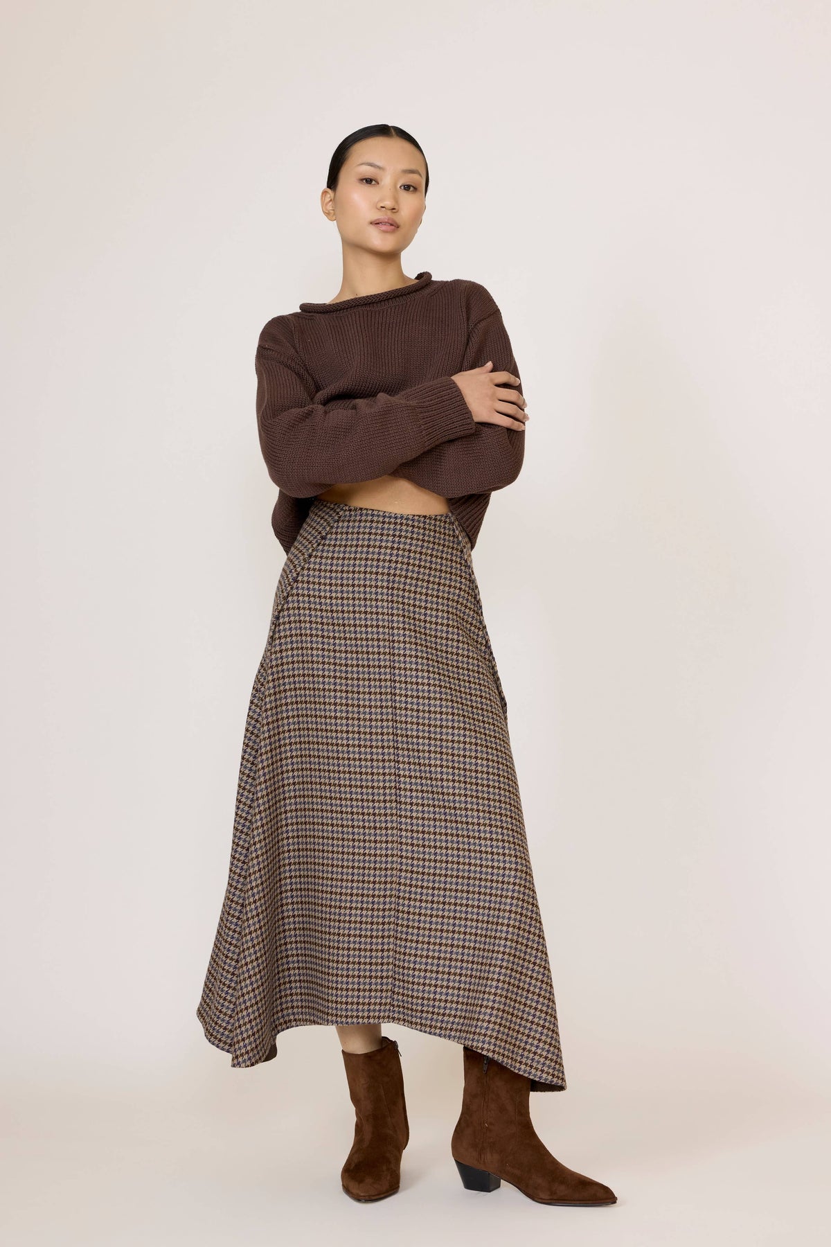 LAUDE wool plaid flowy midi skirt with a relaxed silhouette and classic tartan pattern, styled for a casual or office look.