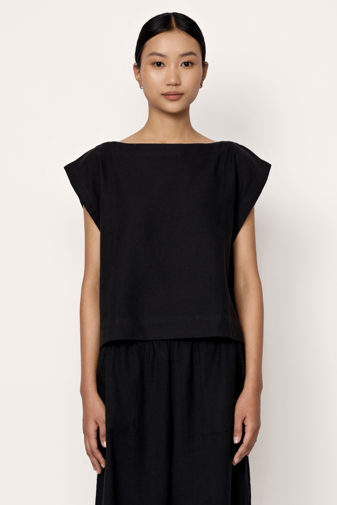 Black everyday top by LAUDE, featuring a simple, comfortable design suitable for casual wear.