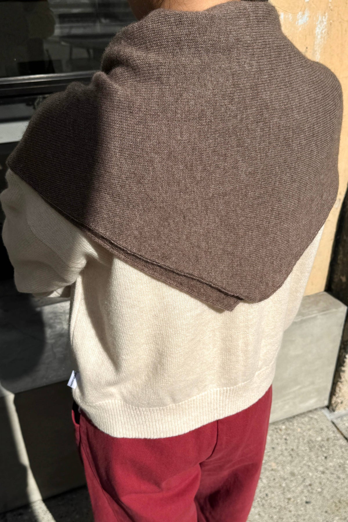 Le Bon Shoppe cashmere shawl draped over a neutral background, showcasing soft, luxurious fabric and elegant design.