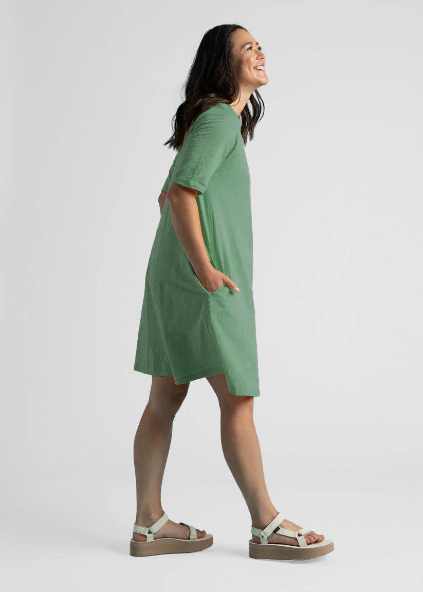 Watercress Good Tee Dress by and for Good laid flat, showcasing its relaxed fit and soft fabric in a natural setting.