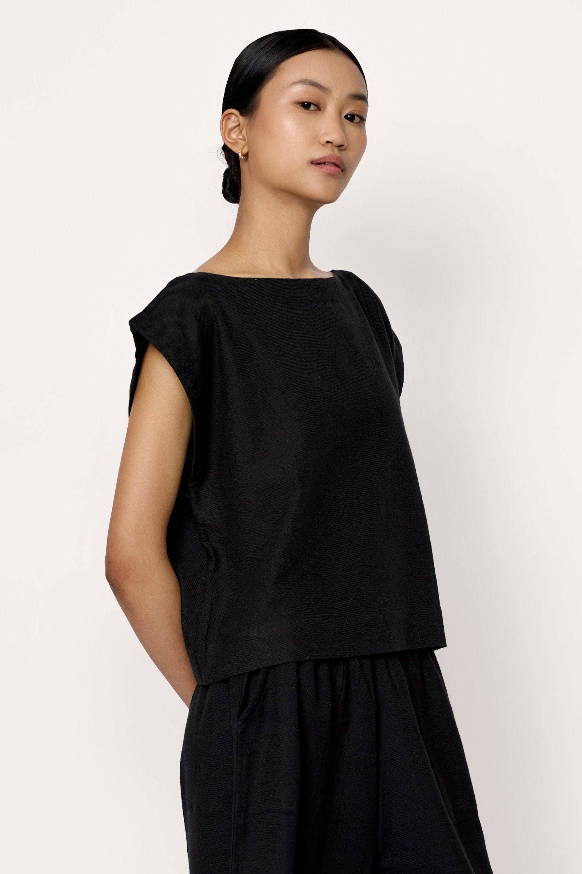 Black everyday top from LAUDE featuring a relaxed fit and soft fabric, styled with a round neckline and long sleeves.