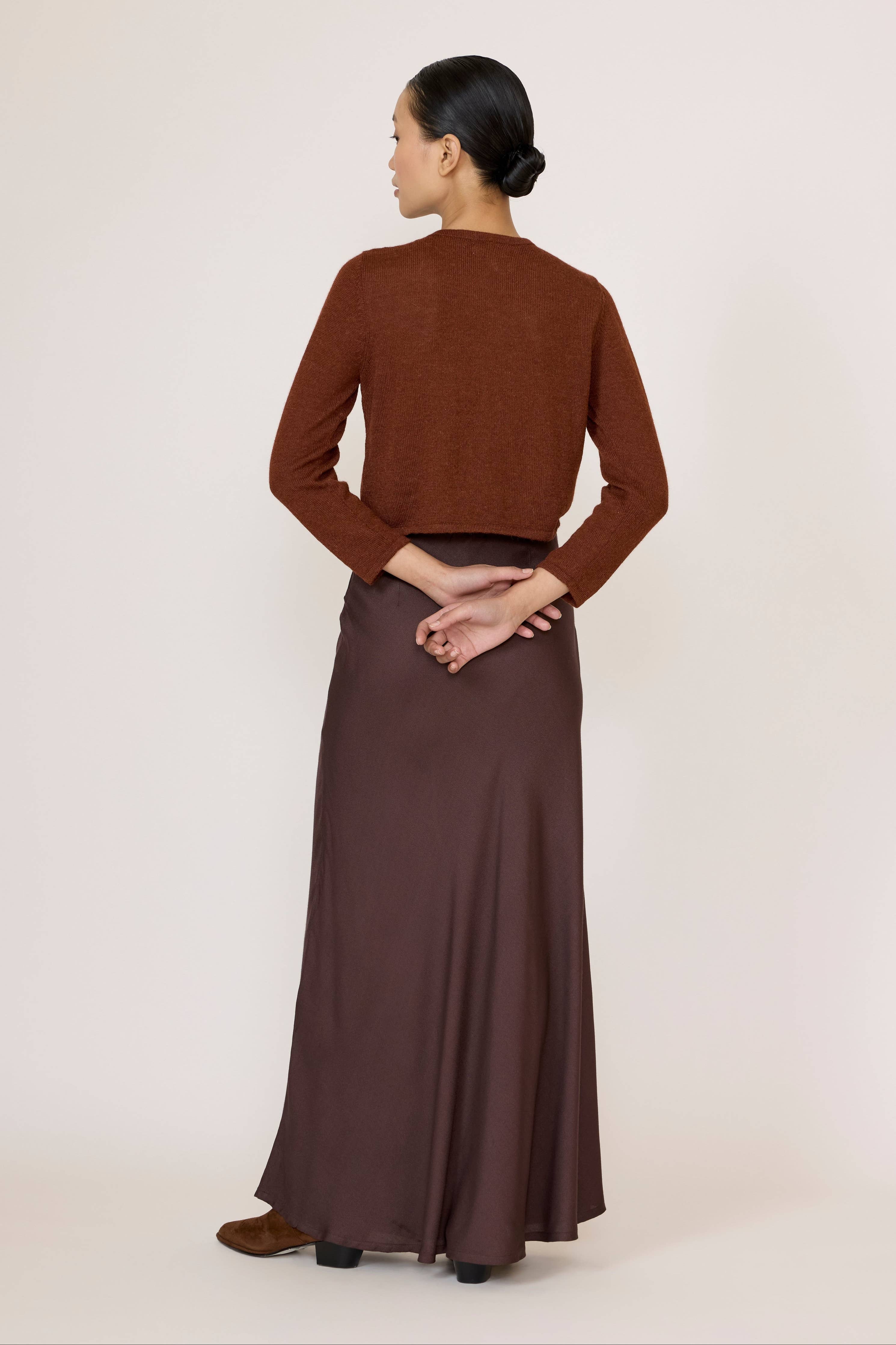 Chocolate brown bias maxi skirt by LAUDE featuring a flowing, elegant design with a comfortable fit and stylish silhouette.