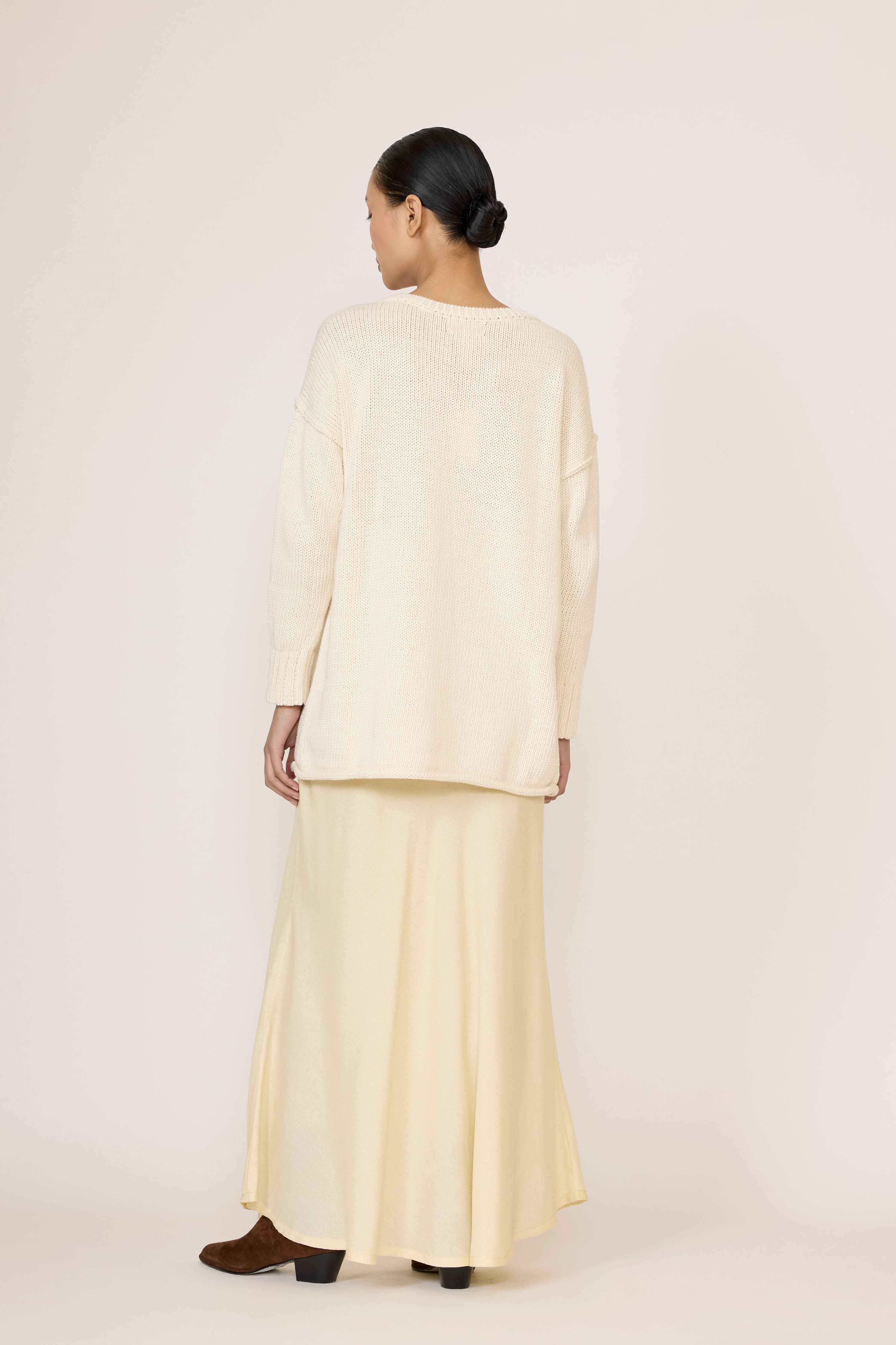 LAUDE oversized ivory crewneck sweater displayed flat with ribbed cuffs and hem, soft knit fabric, and relaxed fit.
