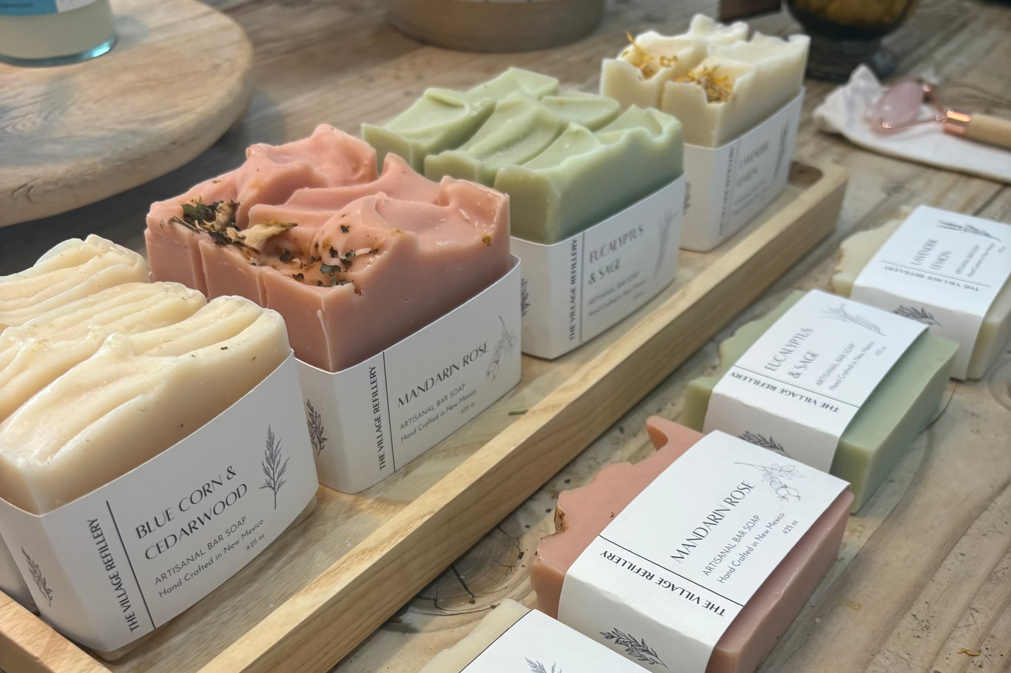 Assorted bars of soap with visible labels on a wooden surface