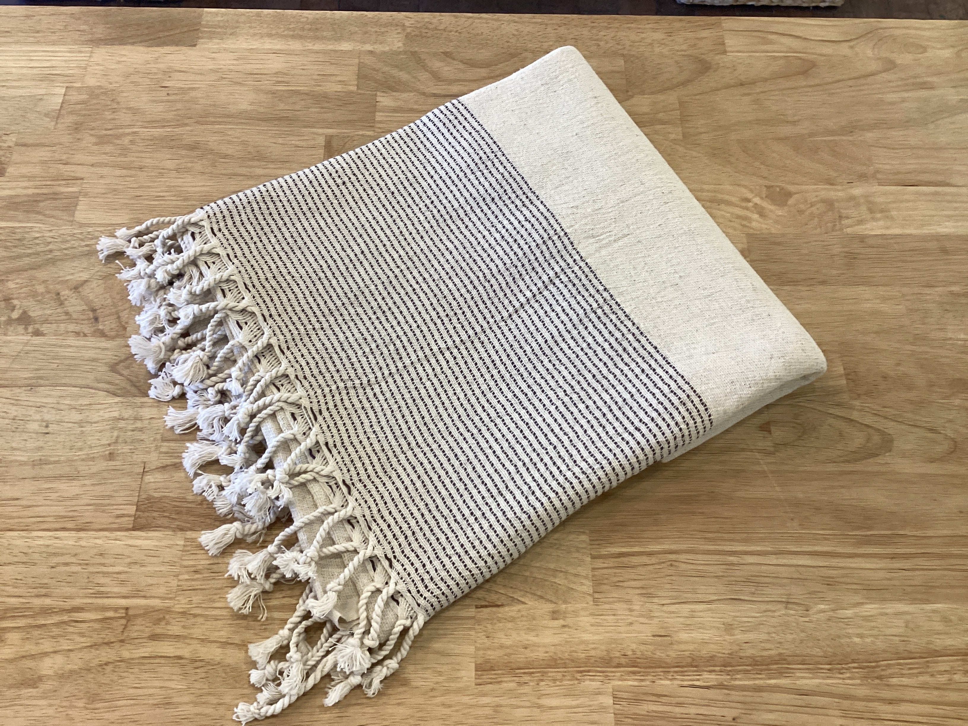 Turkish linen body towel from Lavender Road with soft, breathable fabric and traditional woven design, displayed folded on a neutral background.