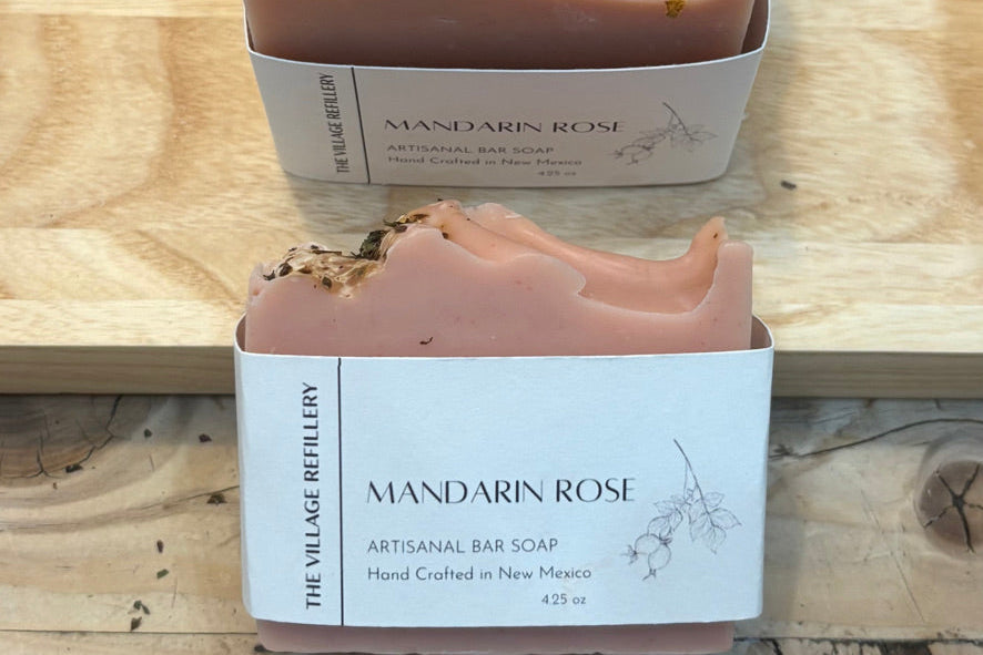Two bars of Mandarin Rose soap from The Village Refillery on a wooden surface.