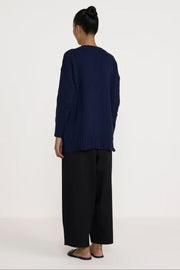 Navy oversized V-neck cotton sweater by Laude the Label, featuring a relaxed fit and knit texture for casual style.