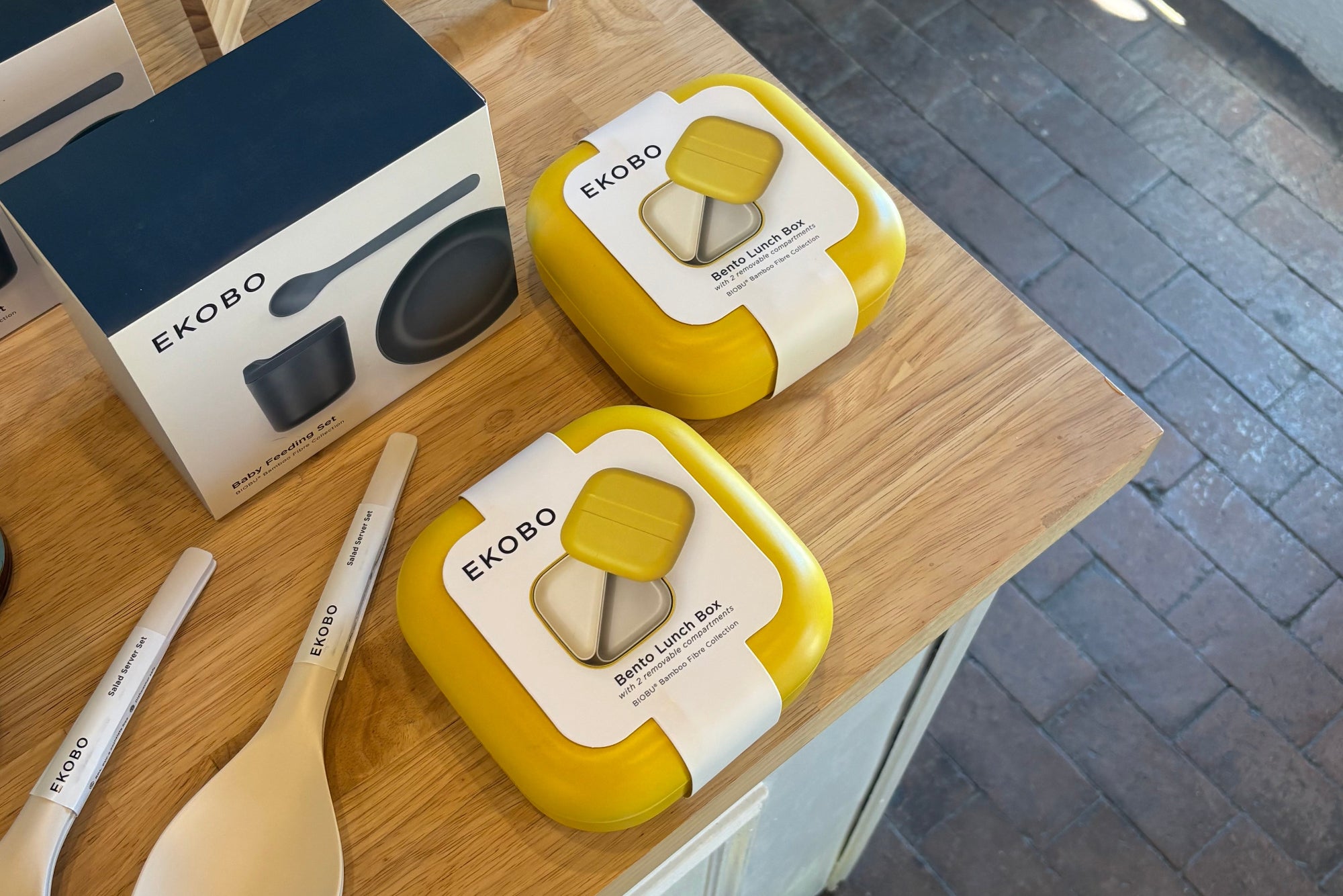 Two yellow lunch boxes with 'Ekobo' branding on a wooden surface.
