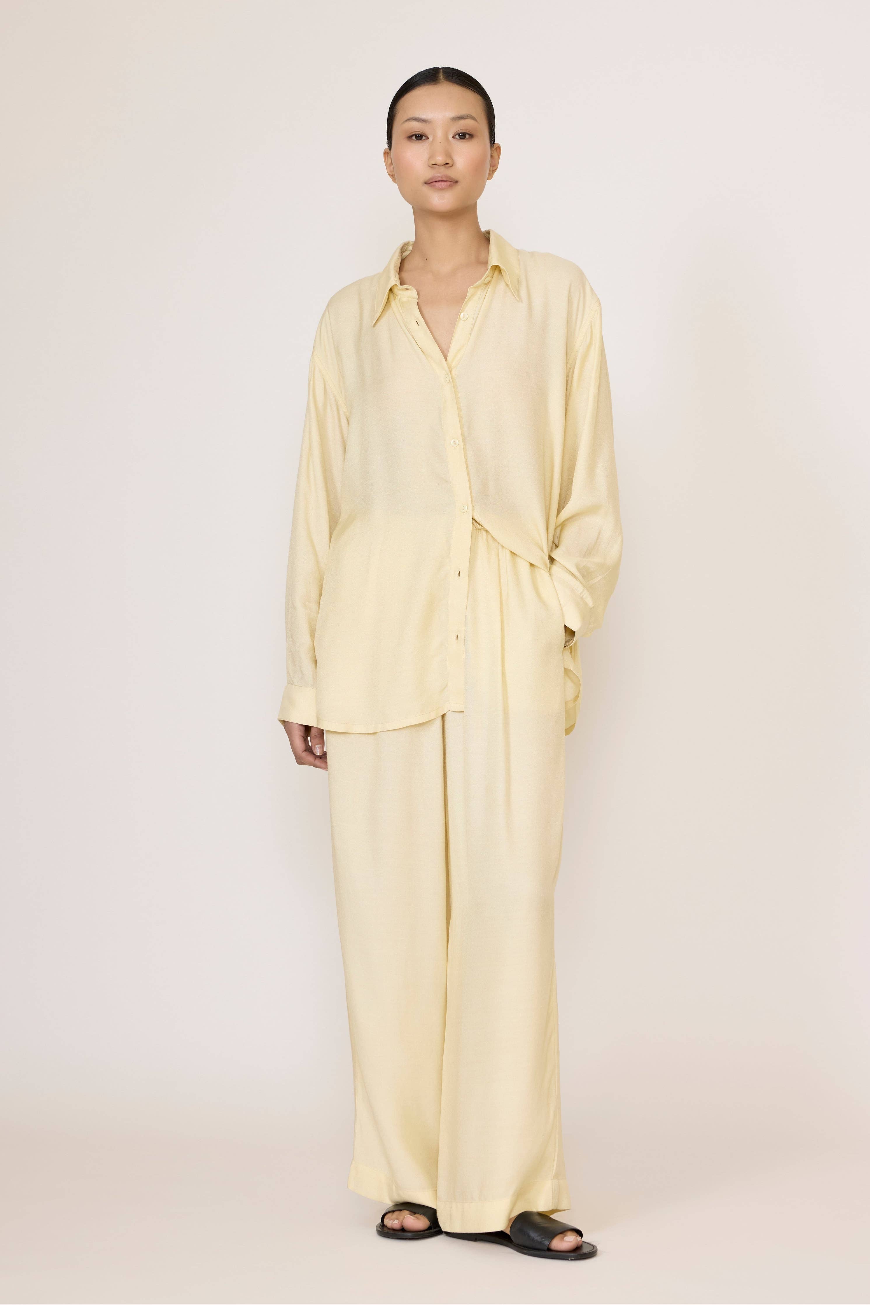 LAUDE Everything Shirt in Butter color, featuring a casual fit with soft fabric and classic collar, displayed on a hanger.