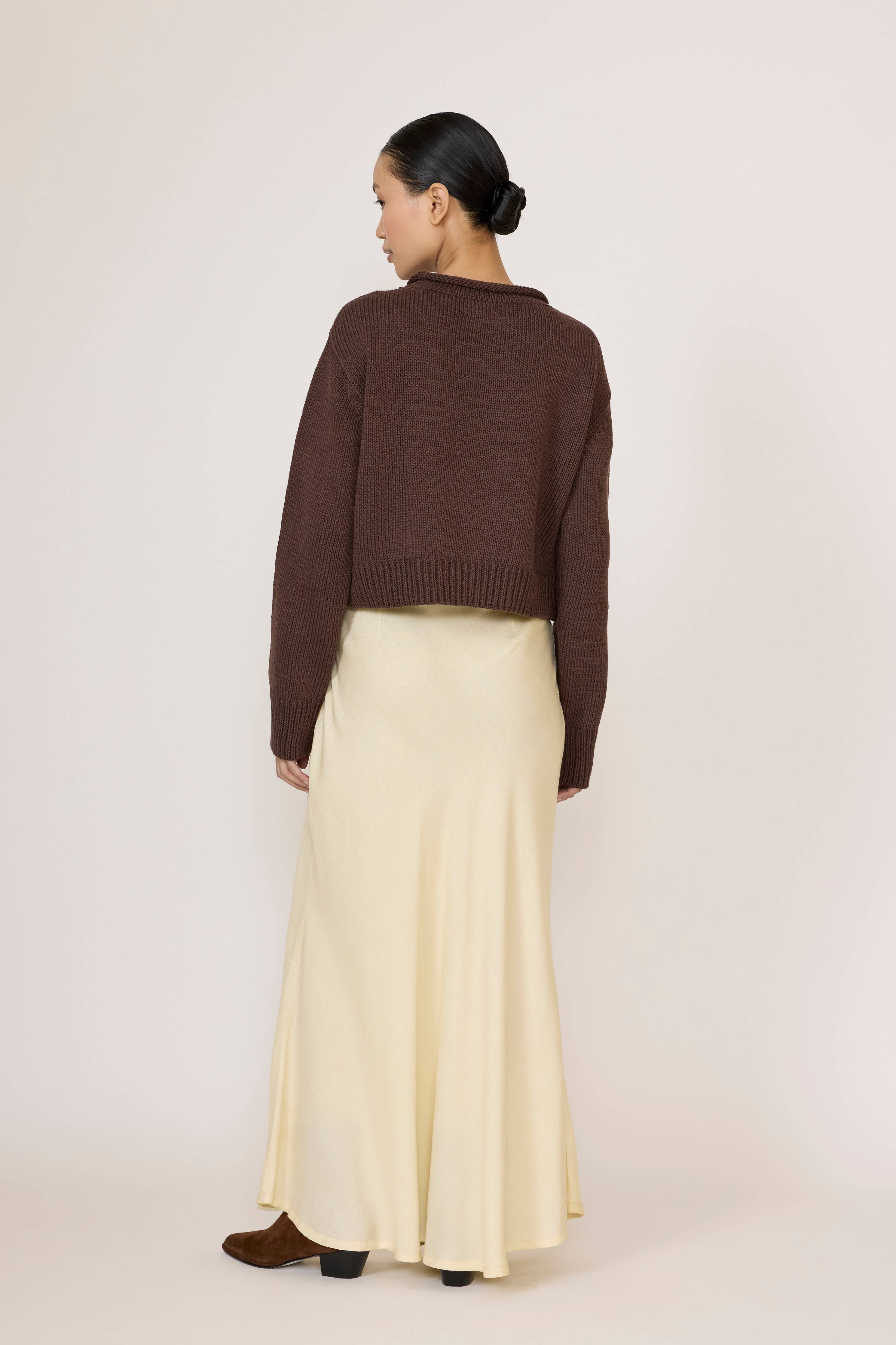 LAUDE Bias Maxi Skirt in Butter yellow, flowing fabric with a high waist and elegant drape, styled for a chic look.