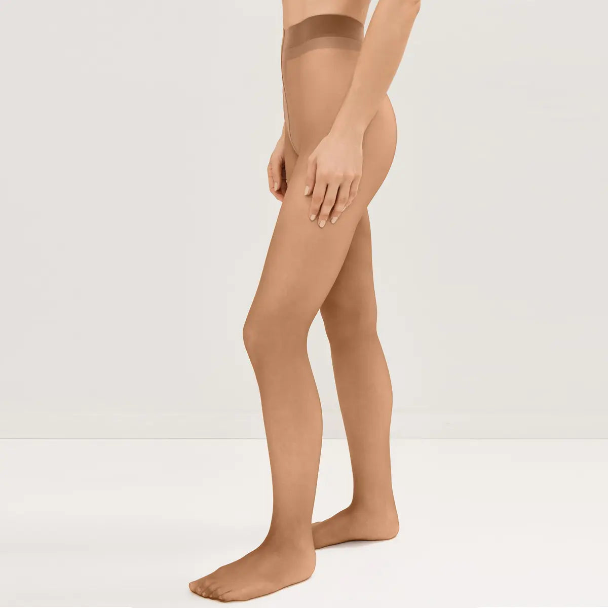 A pair of Flawless Beige Sheer Tights by HOSTcraft, showing smooth, lightweight hosiery with a nude finish on a neutral background.