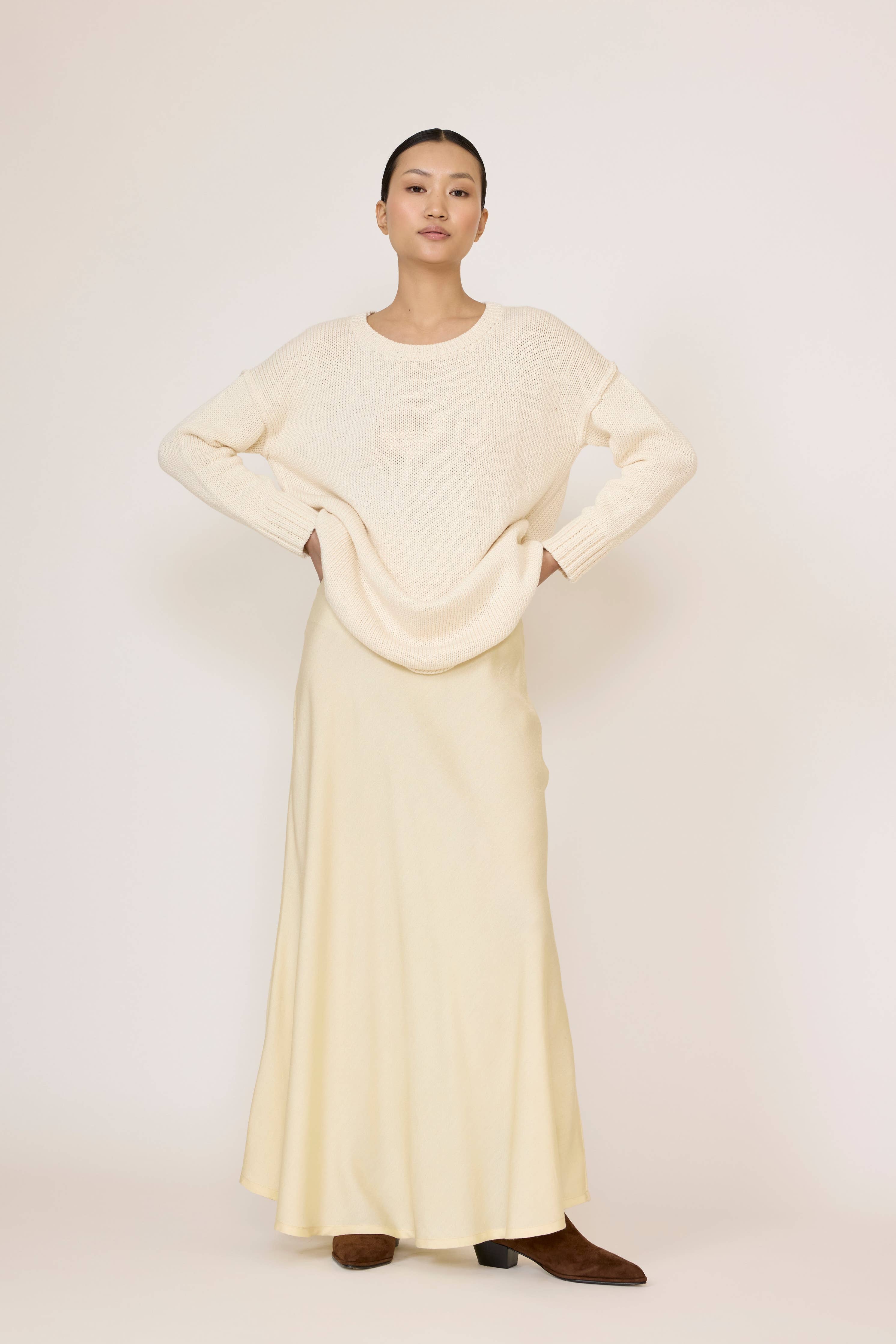 LAUDE Bias Maxi Skirt in butter-colored fabric, flowing design with a high waist and elegant silhouette.