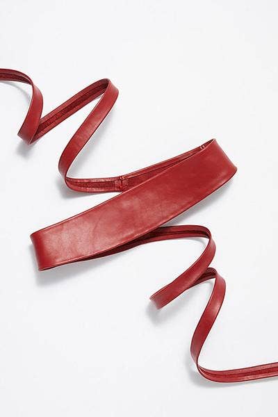 Red leather wrap belt by ADA Collection Belts, adjustable unisex design with stylish, smooth leather finish.