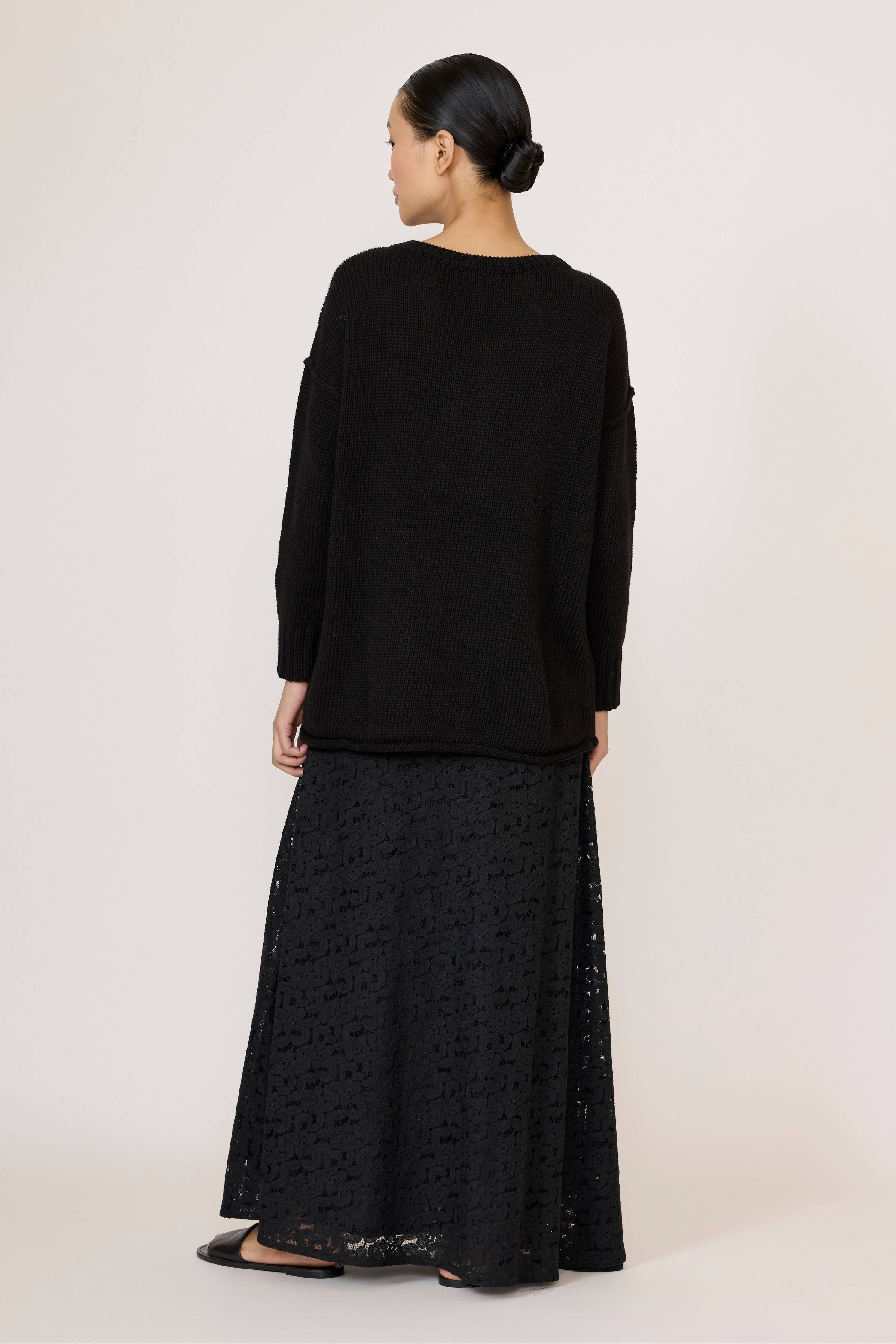 Black LAUDE oversized crewneck sweater, relaxed fit with ribbed cuffs and neckline, casual and comfortable knitwear.