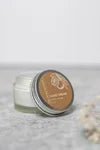 Refillable Vanilla Orange hand cream from The Village Refillery in a sleek body care lotion container with orange and vanilla accents.