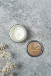 Refillable vanilla orange hand cream bottle from The Village Refillery, featuring a sleek body care lotion design with a pump dispenser.