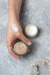 Refillable vanilla orange hand cream from The Village Refillery, showing the lotion container and branding.